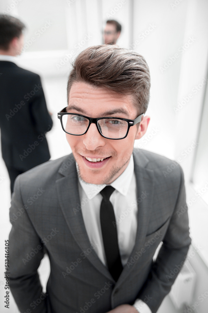 close up.confident young businessman on blurred office background close up.confident young businessman on blurred office background