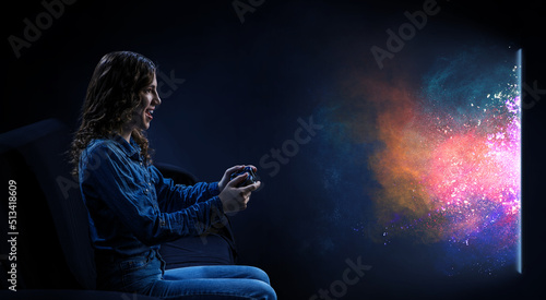 A woman in headphones with a controller set aside in her hands