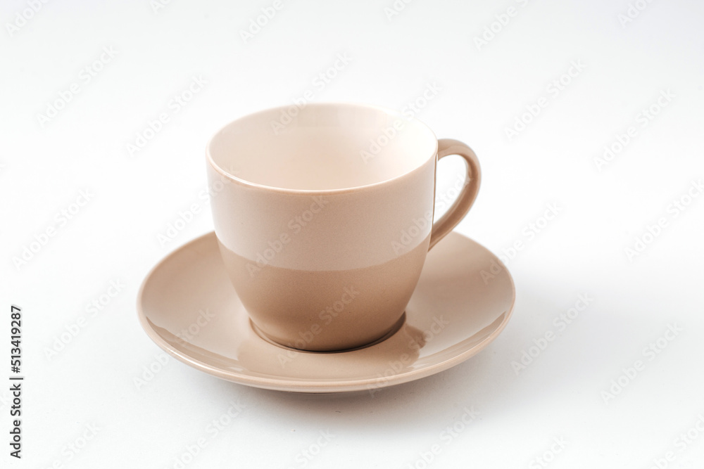 Empty beige coffee ceramic cup and saucer on isolated white background, cut out