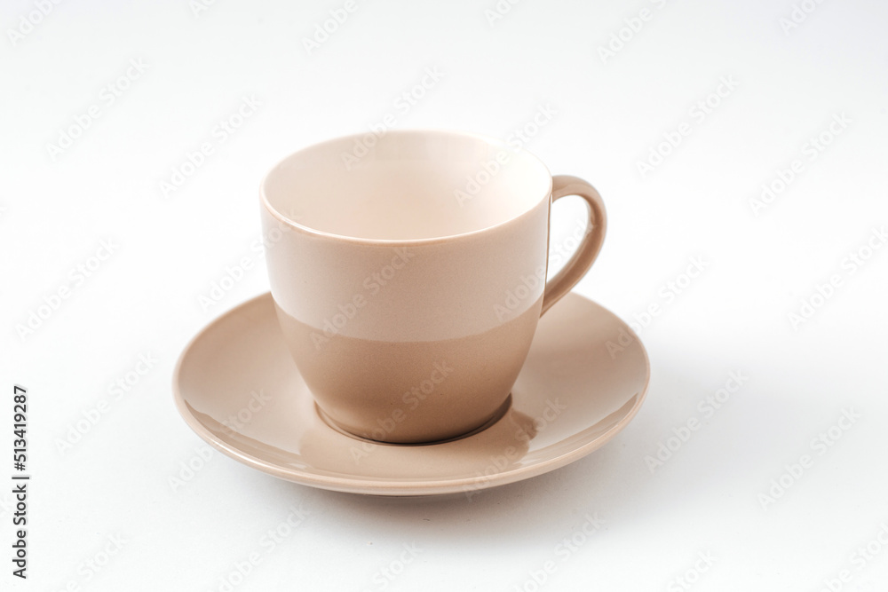 Empty beige coffee ceramic cup and saucer on isolated white background, cut out Empty beige coffee ceramic cup and saucer on isolated white background, cut out