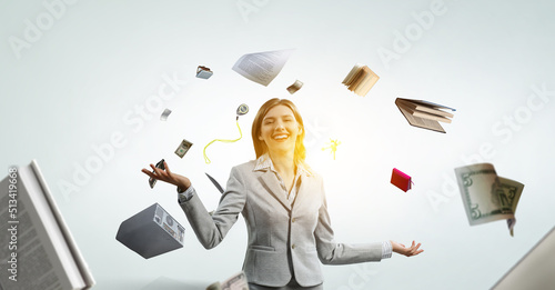 фотографія Young pretty businesswoman juggling with business items