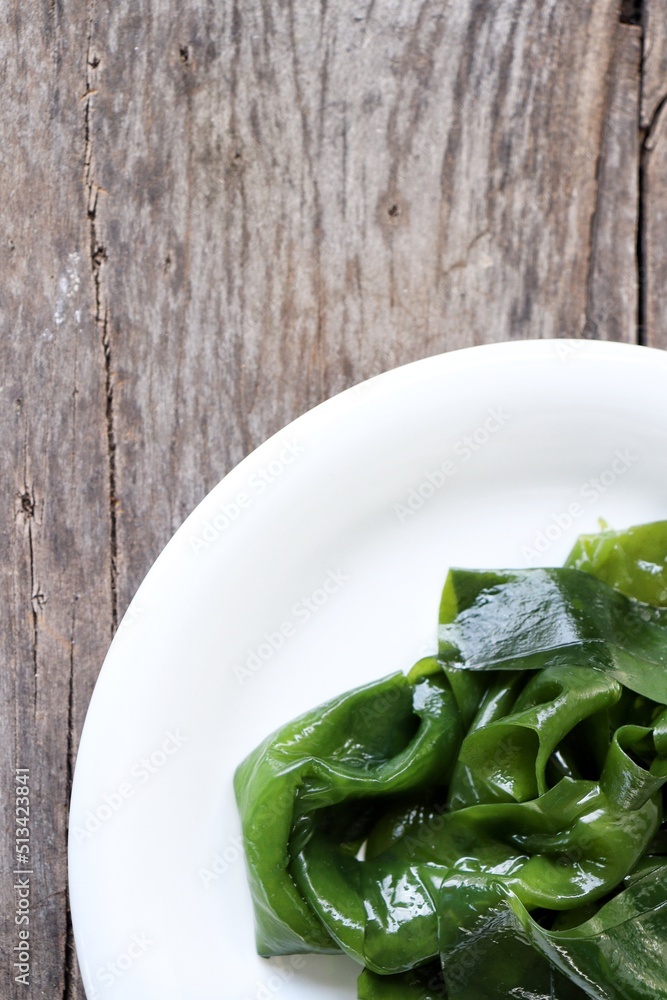 Wakame seaweed on wood background Wakame seaweed on wood background