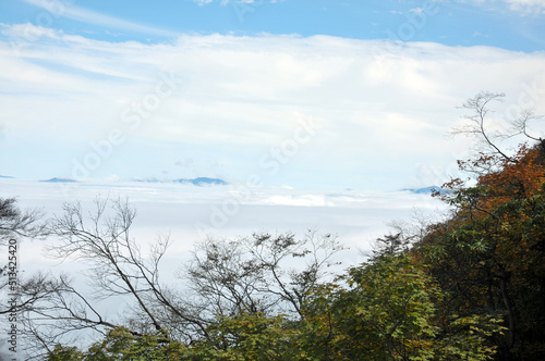 peak mountain with sunlight cloud fog and bright blue sky