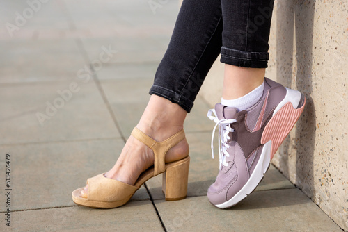 Woman in shoes and sneakers. Woman choosing comfortable sneakers