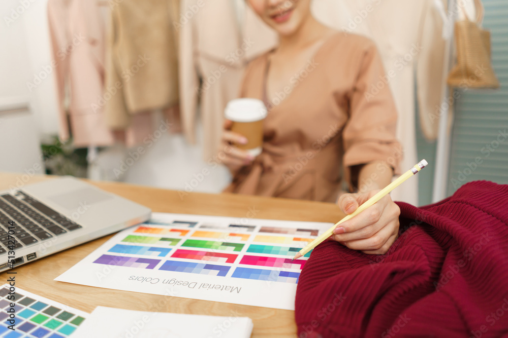 Fashion design concept, Asian female designer drink coffee and choose color for new collection Fashion design concept, Asian female designer drink coffee and choose color for new collection