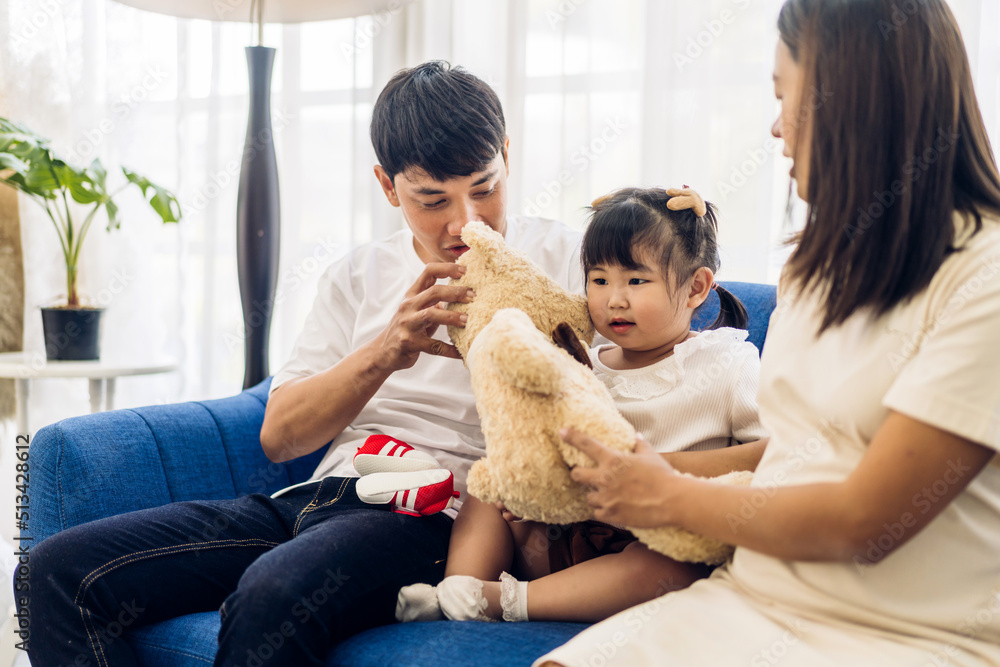 Portrait of enjoy happy love asian family father and mother holding hug cute little asian girl child smiling play and having fun moments good time at home Portrait of enjoy happy love asian family father and mother holding hug cute little asian girl child smiling play and having fun moments good time at home