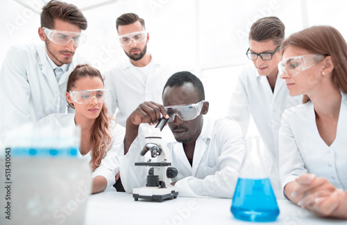 Group of young scientists working in the chemical laboratory