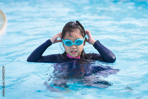 happy children Smiling cute little girl in sunglasses in swimming pool