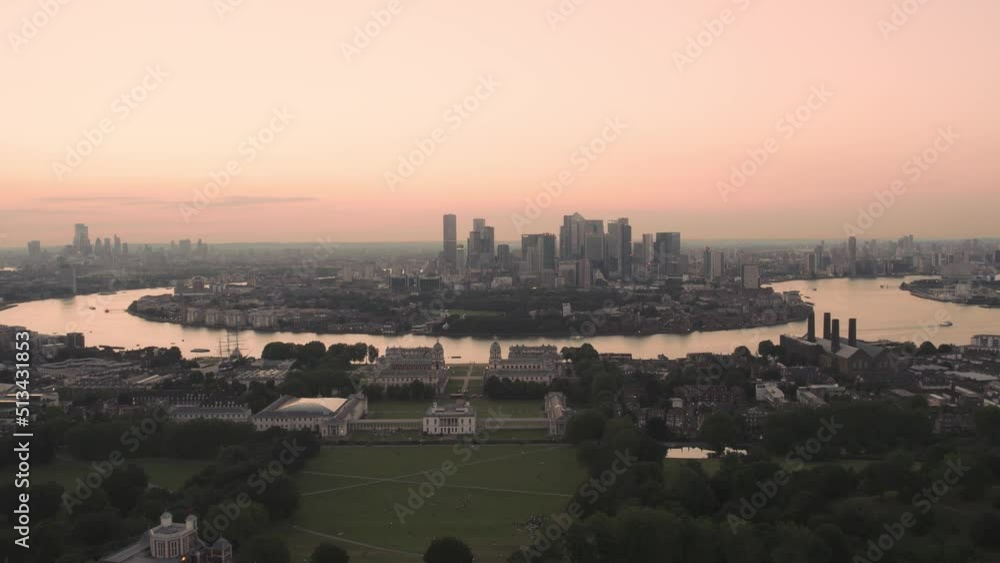 Wide angle sunset Aerial of the Canary Wharf buildings in London at Greenwich park Wide angle sunset Aerial of the Canary Wharf buildings in London at Greenwich park