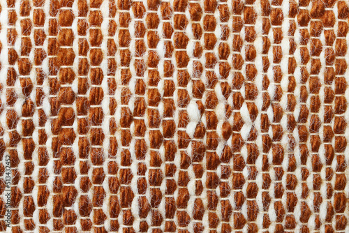 White and brown wool yarn cloth background. Surface of fabric texture in two tone colors.