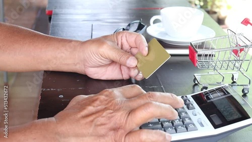 Man using credit card to pay online on his desk at home.Online purchases and use of credit cards concept.