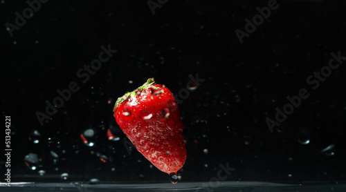 Concept of freshness, fresh strawberry against dark