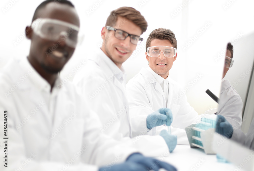 successful group of scientists sitting at their Desk successful group of scientists sitting at their Desk