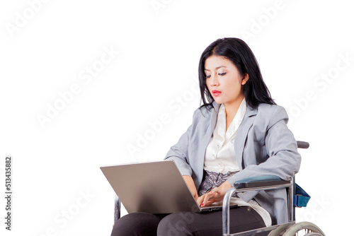 Disabled businesswoman using a laptop on studio