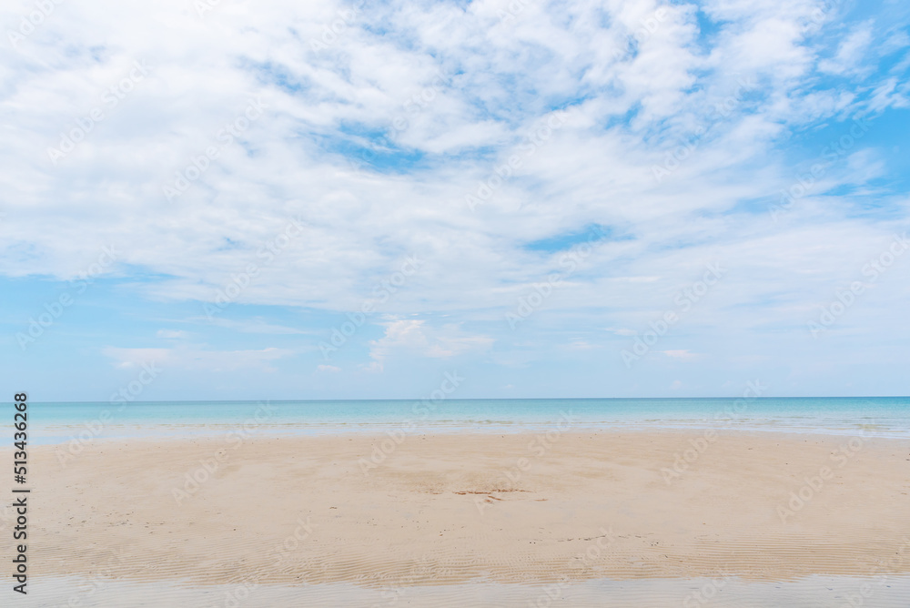 beach and tropical sea under cloudy blue sky