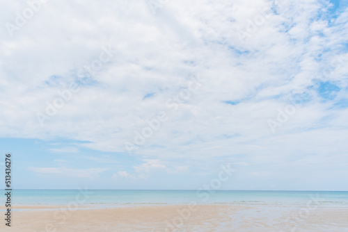 beach and tropical sea under cloudy blue sky