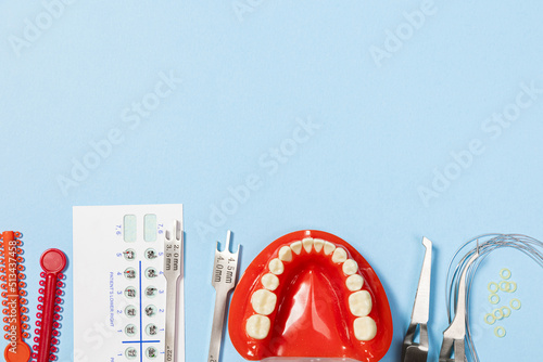a set of special tools for an orthodontist to install braces for a patient. Orthodontic arcs, ligature, locks, positioner, tweezers photo