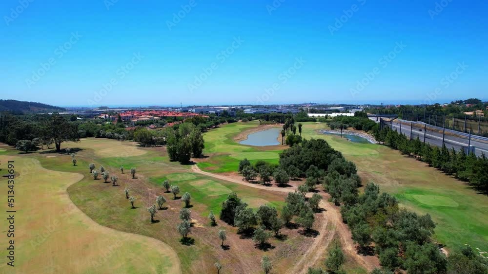 Flying over a golf course towards a lake at Beloura golf camp,Sintra Portugal Flying over a golf course towards a lake at Beloura golf camp,Sintra Portugal