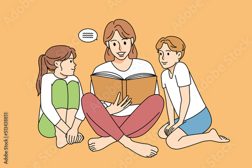 Mother reading book with children 