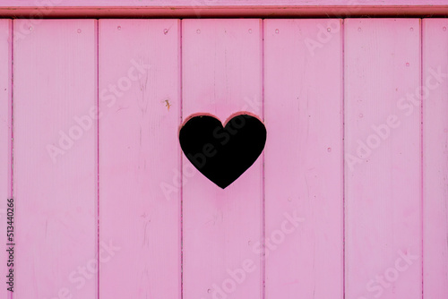 heart on pink door wooden plank in love wedding concept background
