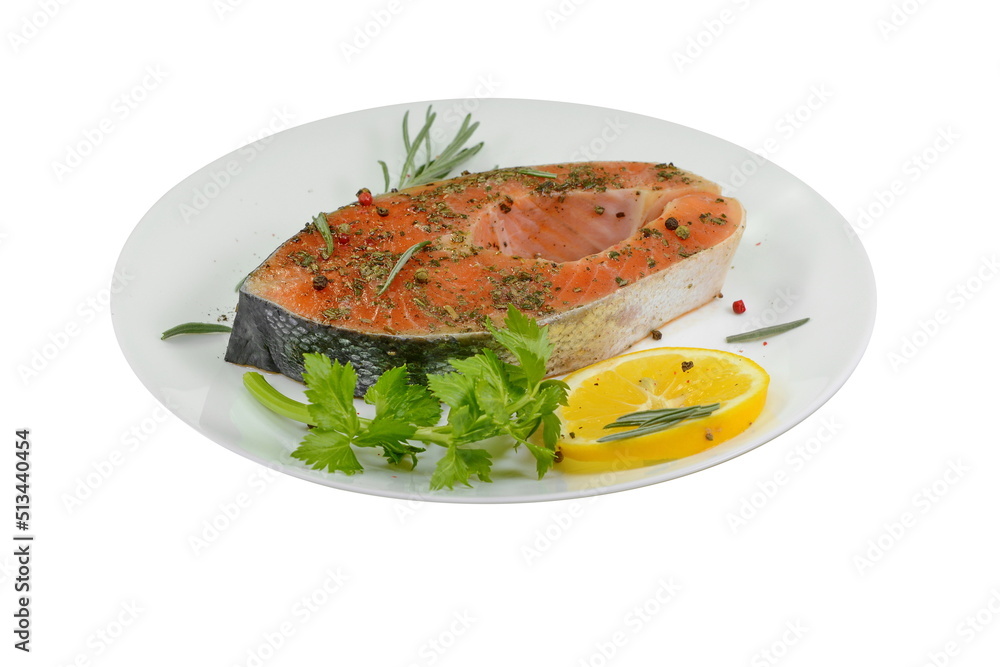Portioned raw salmon chop on plate with lemon and rosemary isolated on white. Portioned raw salmon chop on plate with lemon and rosemary isolated on white.