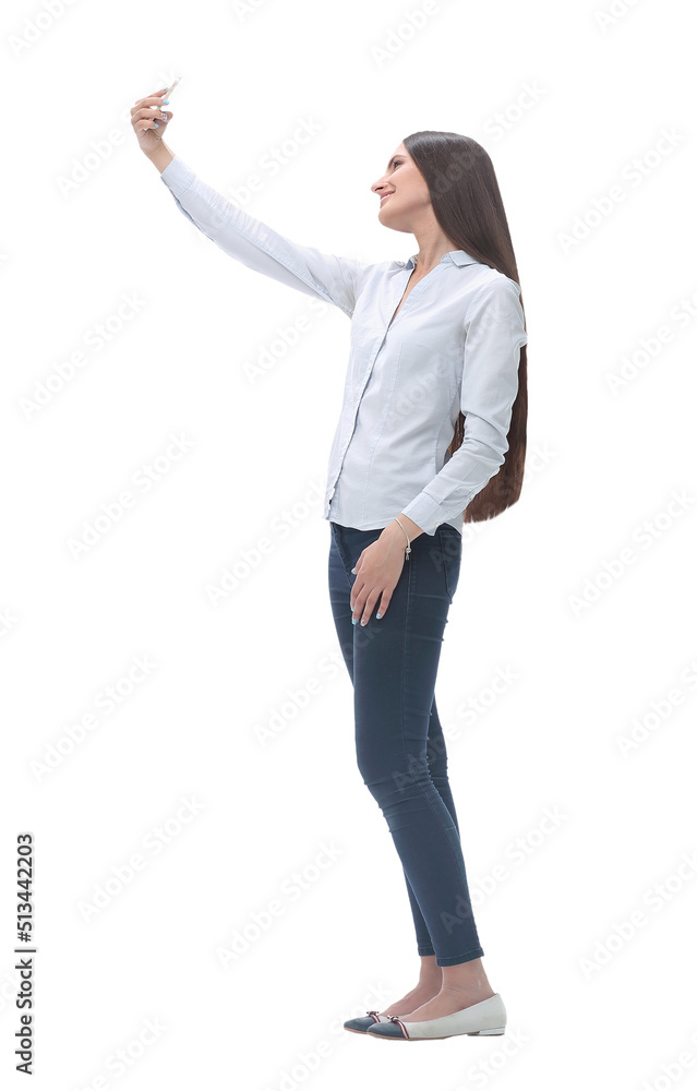 pretty young woman taking selfie on her smartphone . isolated on white pretty young woman taking selfie on her smartphone . isolated on white
