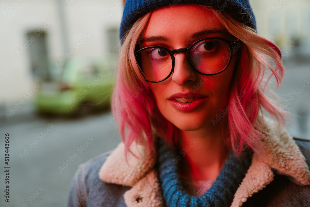 Young white woman posing and looking aside on city street Young white woman posing and looking aside on city street