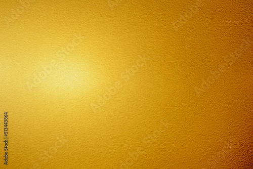 Gold wall texture background. Yellow shiny gold foil on concrete wall surface, vibrant golden luxury wallpaper