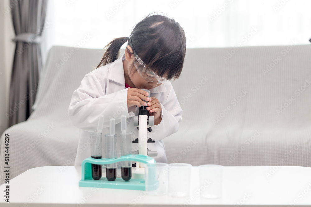 little girl scientist enjoy and excite to examine the color chemical in laboratory by using dropper with day light. Concept of good practice and education of science for children support. little girl scientist enjoy and excite to examine the color chemical in laboratory by using dropper with day light. Concept of good practice and education of science for children support.