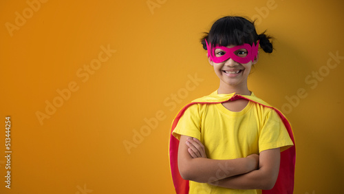 The little girl child in a superhero costume