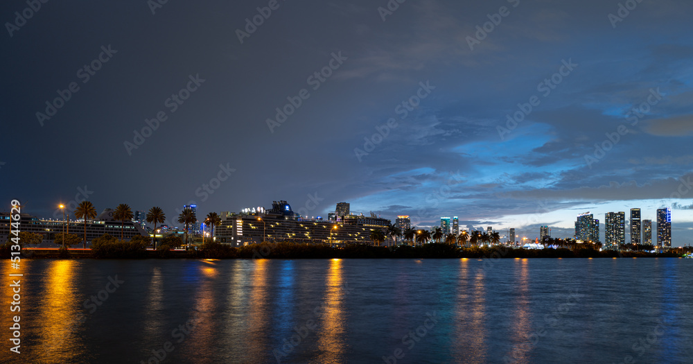 Miami skyline. Miami city skyline panorama with urban skyscrapers over sea with reflection.