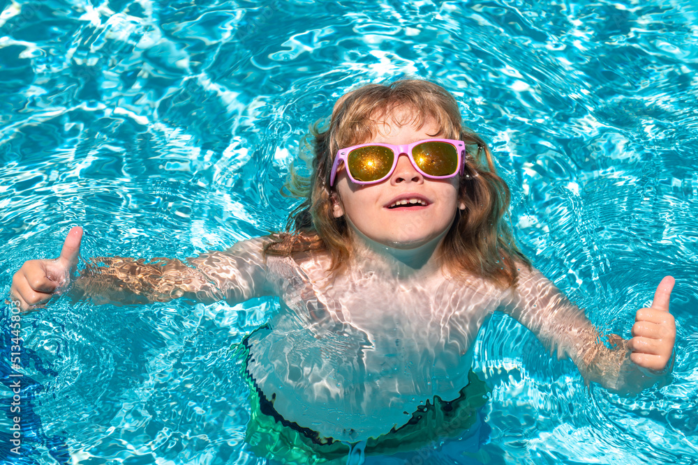 Summer swimming and relax, swim on ring in pool, poolside. Summer vacation fun. Cute kid in swimming pool.