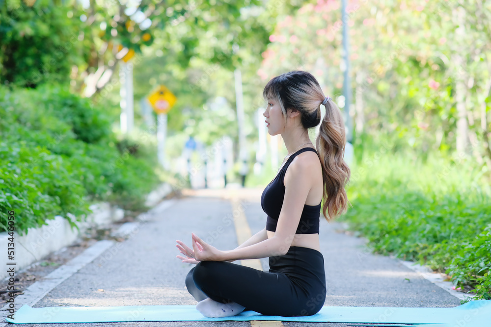 Yoga active lifestyle woman rolling exercise mat on nature background for morning meditation yoga.attractive young woman stretching on a yoga mat. Yoga active lifestyle woman rolling exercise mat on nature background for morning meditation yoga.attractive young woman stretching on a yoga mat.