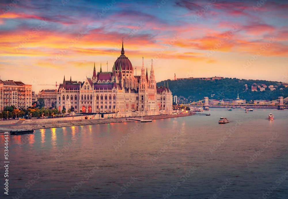 Fototapeta premium Attractive evening view of Parliament house. Astonishing summer cityscape of Budapest. Amazing sunset in Hungary, Europe. Traveling concept background.