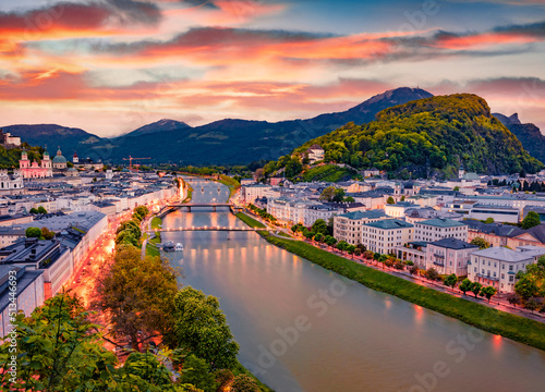 Aerial summer cityscape of Salzburg, Old City, birthplace of famed composer Mozart. Picturesque sunset in Eastern Alps, Austria, Europe. Stunning evening landscape with Salzach river.