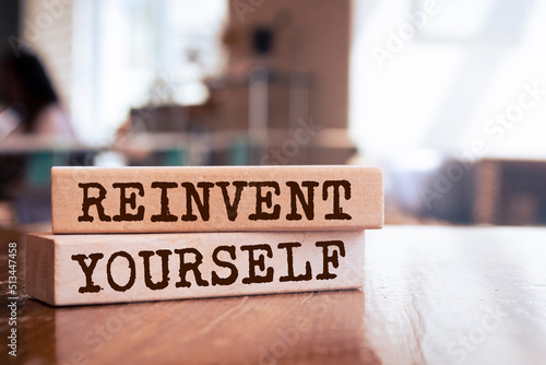 Wooden blocks with words 'reinvent yourself'.  photo