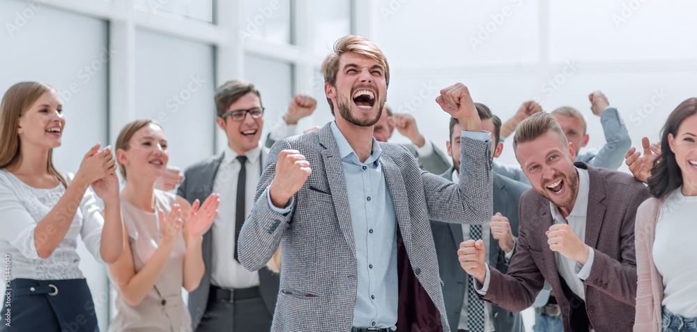 © ASDF - cheerful employees congratulating a colleague on the promotion