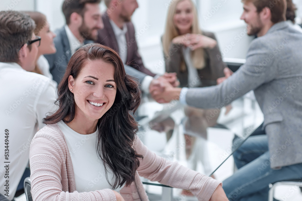smiling business woman sitting in front of the table in the meeting room smiling business woman sitting in front of the table in the meeting room