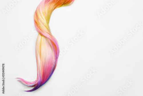 Strand of beautiful multicolored hair on white background  top view