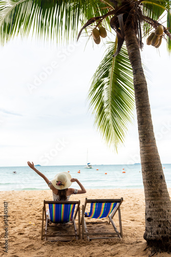 Young woman sitting on the beach chair.