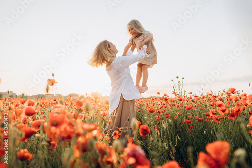 Happy mother lifting daughter in air photo