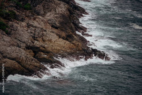 The scenery of the wave on the rocky bay.