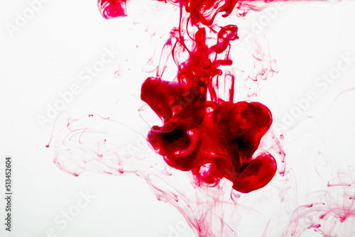 selective soft focus red liquid like blood drop in to clear water