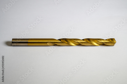 Iron drill bit made of brass with isolated focus concept on white background. Close up of drill bits