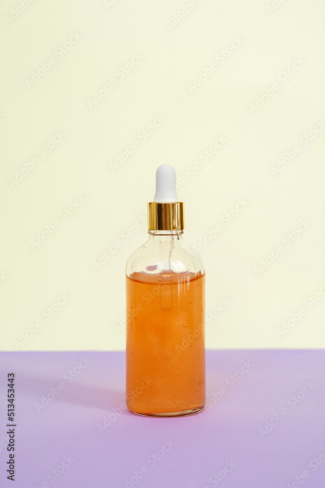 Front view of orange face serum bottle.