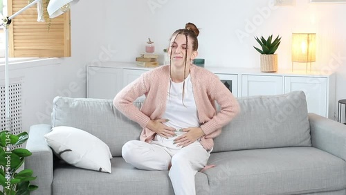 a woman has a stomach ache. critical days, menstruation, indigestion photo