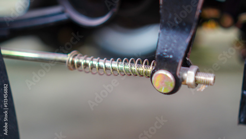 Metal springs of motorcycle brake system. Closeup of rear motorcycle drum brake system. 