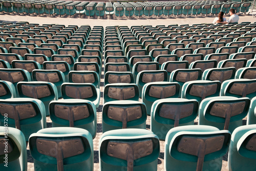 Empty Plastic Chairs at the Stadium © erika8213