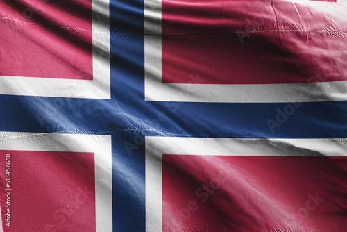 The national flag of Norway is red with a navy blue Scandinavian cross fimbriated in white that extends to the edges of the flag; the vertical part of the cross is shifted to the hoist side in the sty photo