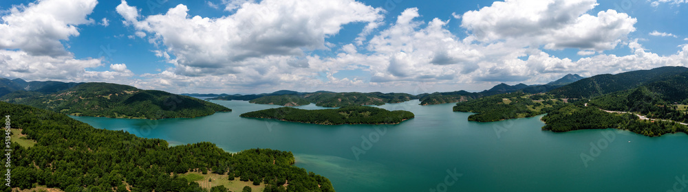 Plastiras Lake, Greece panoramic aerial view, blue cloudy sky. Artificial lake in Karditsa, Thessaly Plastiras Lake, Greece panoramic aerial view, blue cloudy sky. Artificial lake in Karditsa, Thessaly